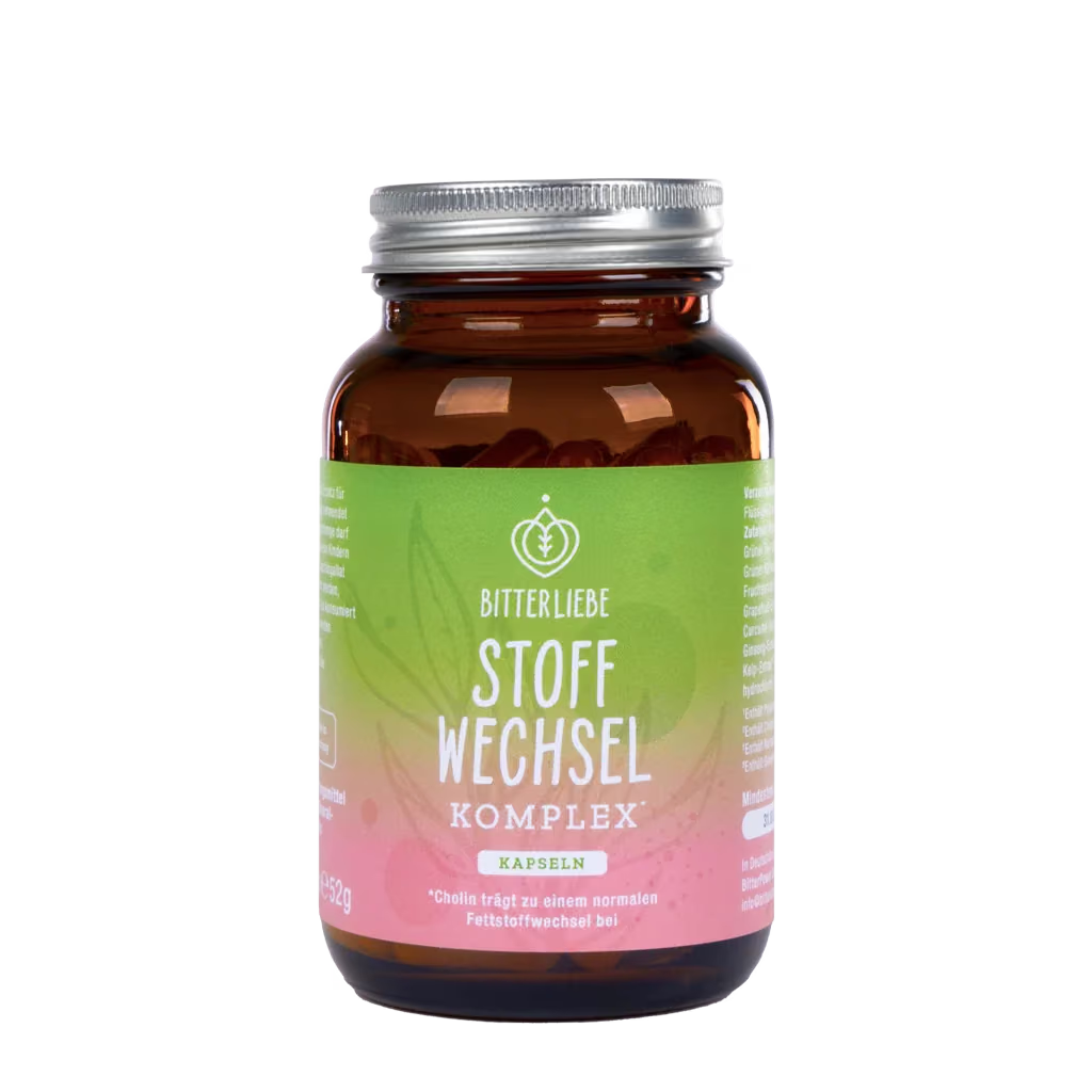 Braune Glasdose mit Silberdeckel und grün-rosa Etikett neben einer Kaffeetasse